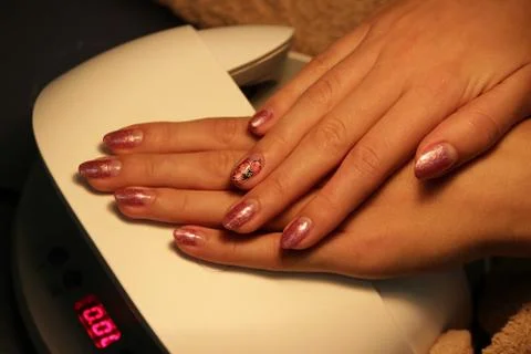 Ready manicure shellac. color shellac pink gold. Stock Photos