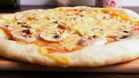 Ready pizza close-up on the Board, on the table. Video stock 114751570