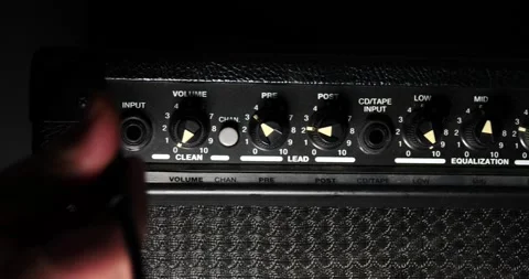 Ready to rock and roll turning on amplifier plugging in guitar wire turning up Stock Footage 204900640