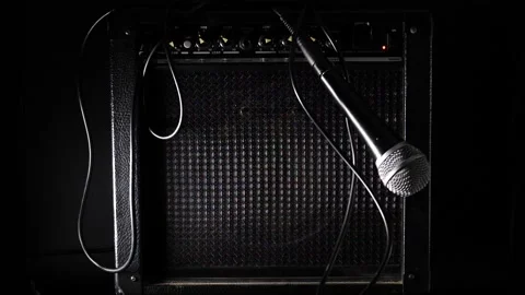 Ready to rock microphone falling slow motion across amplifier Stock Footage 204959861