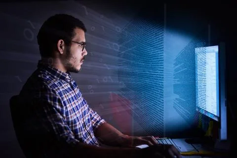 Ready, set, code. Cropped shot of a young computer programmer looking through Stock Photos