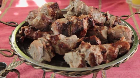 Ready skewers of various types of meat cooked on charcoal are removed from a ske Stock-Footage 116436459
