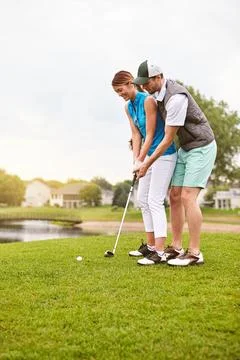 Ready for some golf. an affectionate young couple spending a day on the golf Fotos de archivo