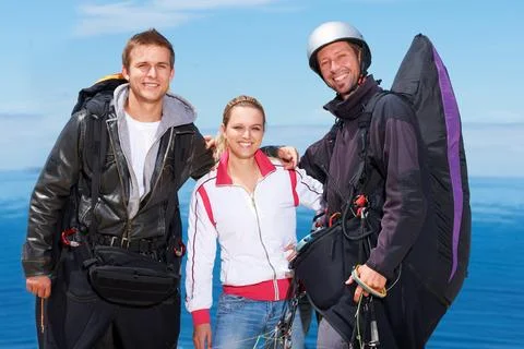 Ready for some paragliding. Three para gliders posing for the camera before Stock Photos