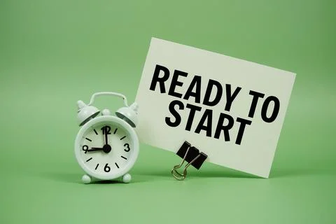 Ready to start text message on paper card with alarm clock on green backgroun Stock Photos
