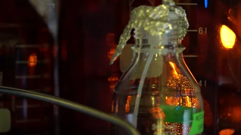 Reagent bottle holds solution as technician seals foil cap Stock Footage 327046766