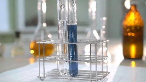 Reagents in the laboratory. Test tubes with clear and blue liquid Stock Footage 115101560