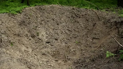 A real big hole in the ground after being hit by an artillery shell. Stock Footage 194852095