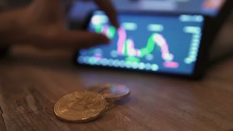 Real bitcoin coins on table. Block-chain, trading online, Cryptocurrency trend Stock Footage 117063298