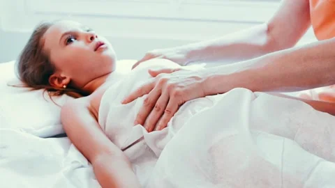 Real doctor osteopath hands does physiological and emotional therapy for kid Stock Footage 158287361