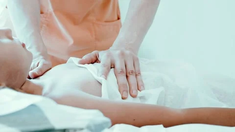 Real doctor osteopath hands does physiological and emotional therapy for kid Stock Footage 158287460