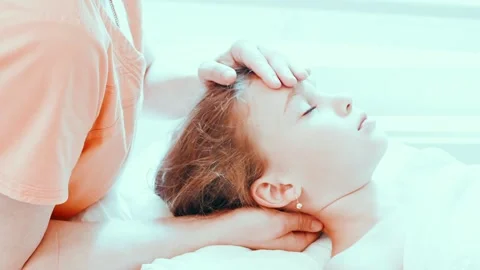 Real doctor osteopath hands does physiological and emotional therapy for kid Stock Footage 158287662