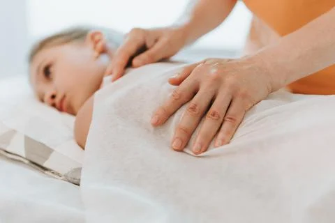 Real doctor osteopath hands does physiological and emotional therapy for eigh Stock Photos