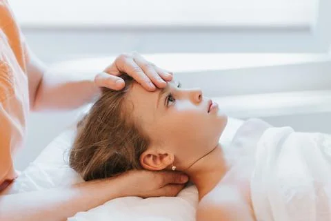 Real doctor osteopath hands does physiological and emotional therapy for eigh Stock Photos