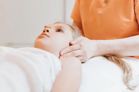 Real doctor osteopath hands does physiological and emotional therapy for eigh Stock Photos