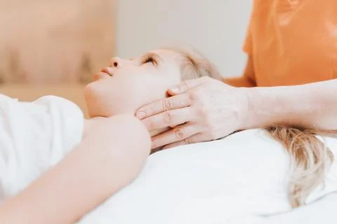 Real doctor osteopath hands does physiological and emotional therapy for eigh Stock Photos
