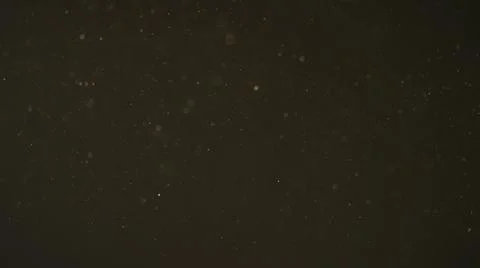 Real dust particles in air with back light over black background Stock Photos