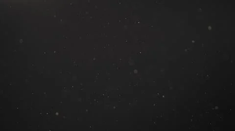 Real dust particles in air with back light over black background Stock Photos