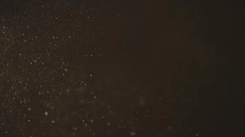 Real dust particles in air with back light over black background Stock Photos