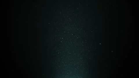 Real dust particles floating . Dust particles in the air. Light blue background Stock Footage 243848835