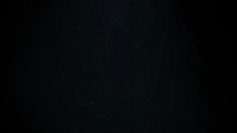 Real dust particles floating . Dust particles in the air. Light blue background Stock Footage 243848843