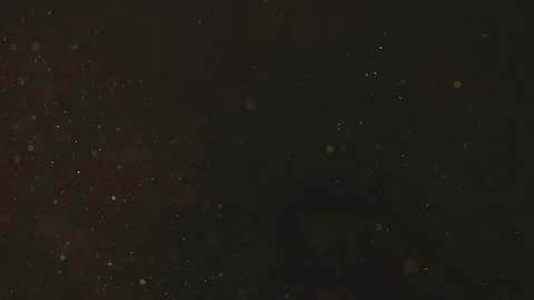 Real dust particles floating over black background Fotos Stock
