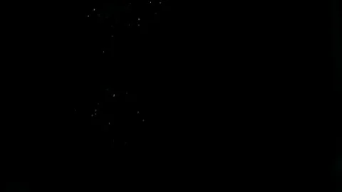 Real dust particles slowly floating down, isolated on black background Video stock 70981017