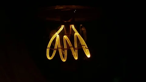 Real Edison light bulb flickering. Vintage filament Edison light bulb. Close up. Stock Footage 75473592