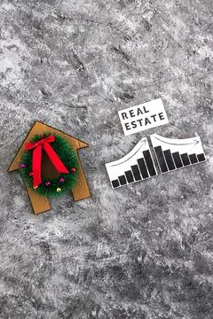 Real Estae text and graph with stats going up and down next to cardboard ho.. Foto stock