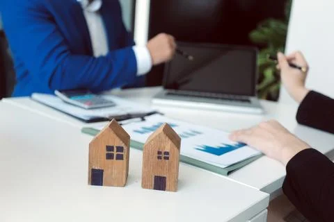 Real estate agent and customer signing contract to buy house, insurance or .. Stock Photos