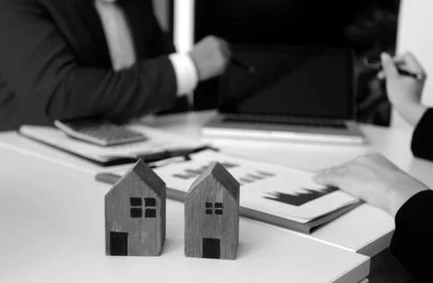 Real estate agent and customer signing contract to buy house, insurance or .. Stock Photos