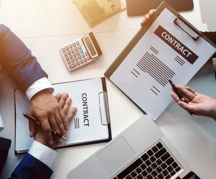 Real estate agent and customer signing contract to buy house, insurance or .. Stock Photos