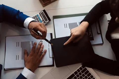 Real estate agent and customer signing contract to buy house, insurance or .. Stock Photos