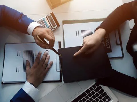 Real estate agent and customer signing contract to buy house, insurance or .. Stock Photos