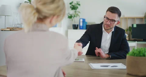 Real Estate Agent Concludes Transaction, Shakes Hands with Client Video stock 281117319