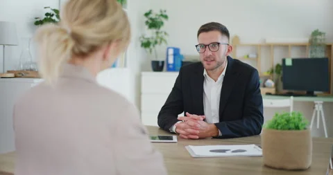 Real Estate Agent Discussing with Client in Office Stock Footage 281117046