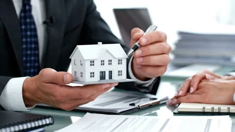 Real Estate Agent Explaining Property Details with Model. Stock Footage 316280509