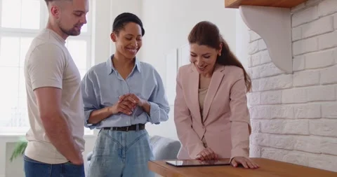 Real estate agent giding clients family couple about house, introducing them new Stock Footage 333713404