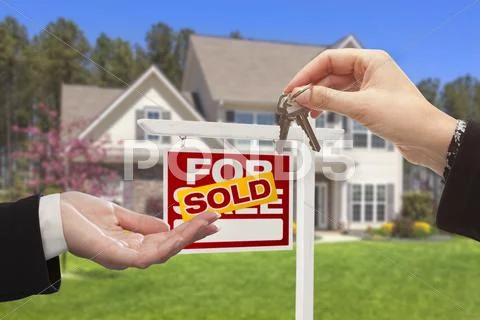 Real Estate Agent Handing Over the House Keys in Front of a Beautiful ...
