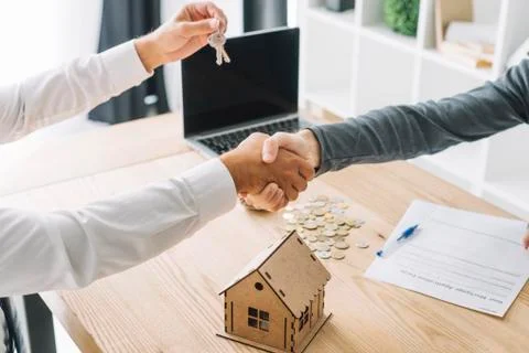 Real estate agent holding house key to his clien, concept for real estate 写真素材