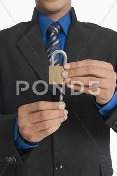 Real estate agent inserting a key in a lock Stock Photos