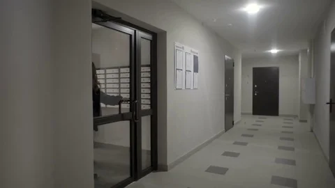 Real estate agent leads a client to the entrance of a new house Stock Footage 81831211