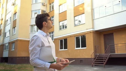 A real estate agent meets with a client near a sale item or leases Stock Footage 111837684