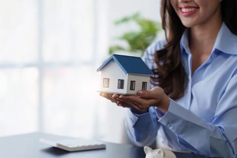Real Estate agent offers home ownership and life insurance to client Stock Photos