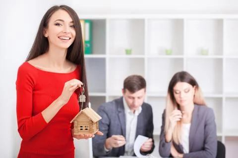 Real estate agent presenting a contract for house investment to futur owners Stock Photos