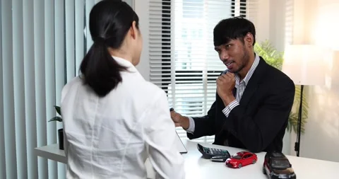 A real estate agent presents a property sale contract to a client Stock Footage 343290609