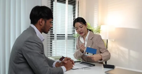A real estate agent presents a property sale contract to a client Stock Footage 343291246