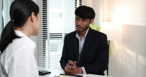 A real estate agent presents a property sale contract to a client Stock Footage 343291589