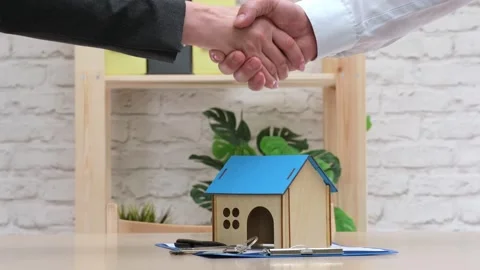 Real estate agent shaking hands with buyer after signing contract. Buy property Stock-Footage 274204282