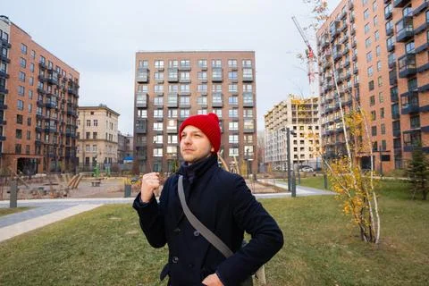 Real estate agent standing in front of new residential building complex 스톡 사진